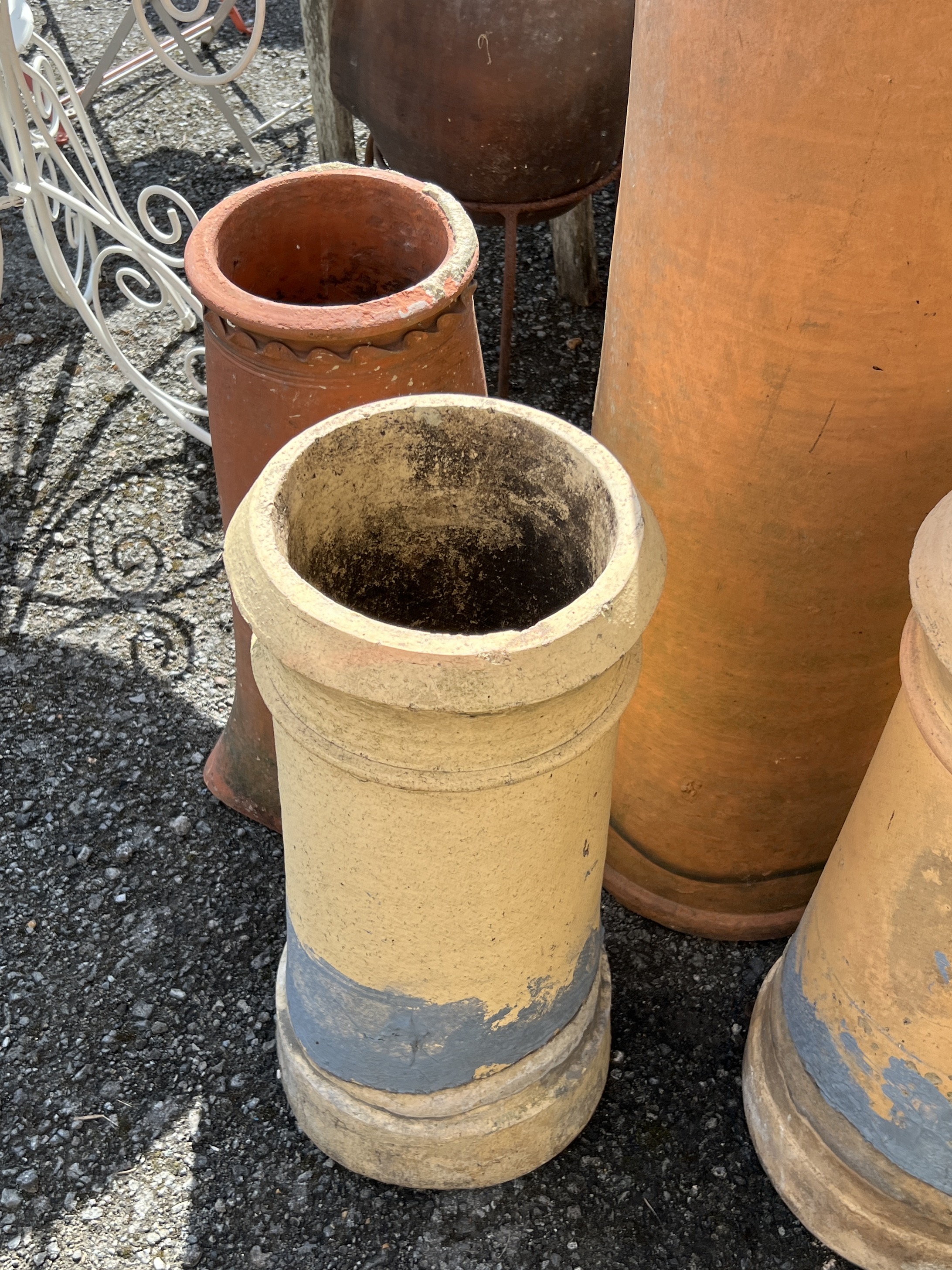 Five terracotta and earthenware chimney pots, largest height 154cm
